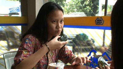 おにぎりを食べるインドネシアの女性